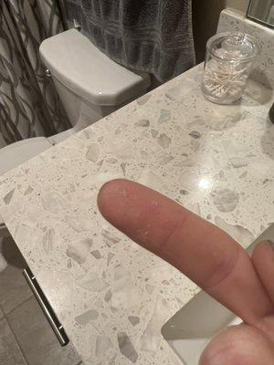 Dust on bathroom counter not cleaned