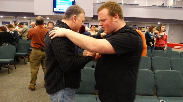 Pastor Gary & his oldest son praying for each other