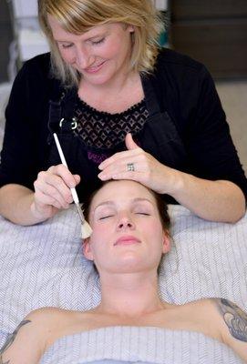 A client receiving a facial treatment
 (photo courtesy of A. Elliot Photography)