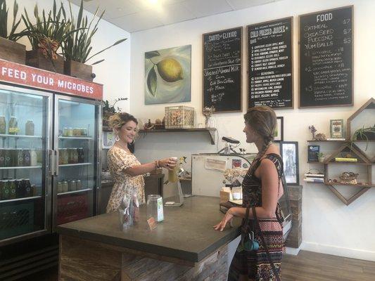 Our staff member Sarah serving up a cold-pressed juice to our long time customer, Shivan.