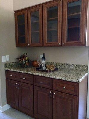 Dry bar area cherry cabinets with glass