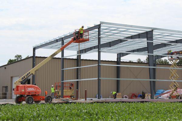 A.C.E. team members are hard at work framing out a future Butler pre-engineered metal building.