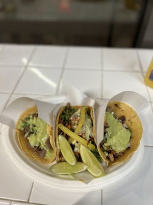 Chicken, carne asada, pork tacos on corn tortillas