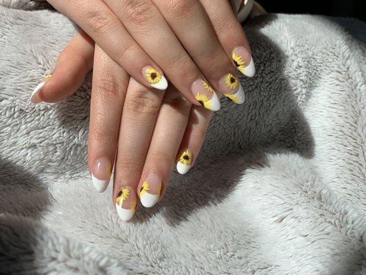 French manicure with sunflower nail art.