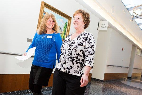 Iora Primary Care's friendly staff walking down the hallway with a patient.