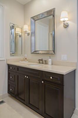 Raised panel Custom Cabinetry in dark wood and Crema Marfil Marble