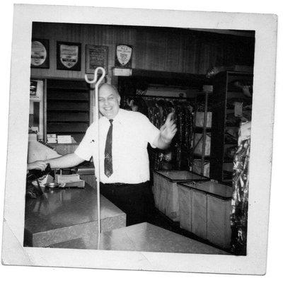 Second generation owner Louis Feigenbaum greets a customer at the counter