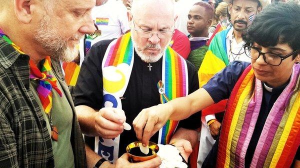 Pastor Curtis serving Communion in Havana, Cuba