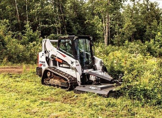 T590 track loader/skid steer with brushcat for brush removal and mulching