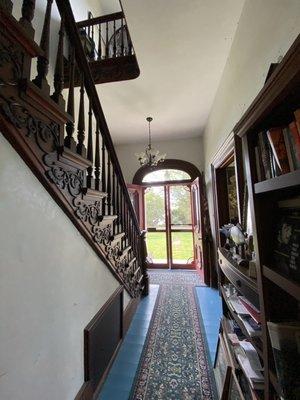 Main hallway with intricate wood staircase