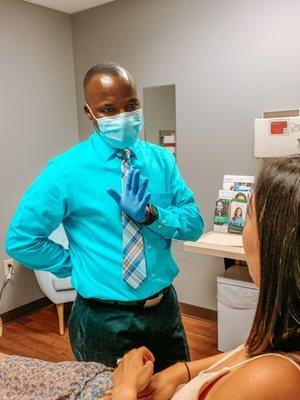 Dr Mulumba - Board Certified in Aesthetic Medicine discussing treatment plan with beautiful BSA patient. DYSPORT, NEO, BOTOX, MICRONEEDLING.