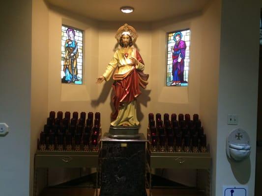 votive candles to the Sacred Heart of Jesus, left side of main chapel