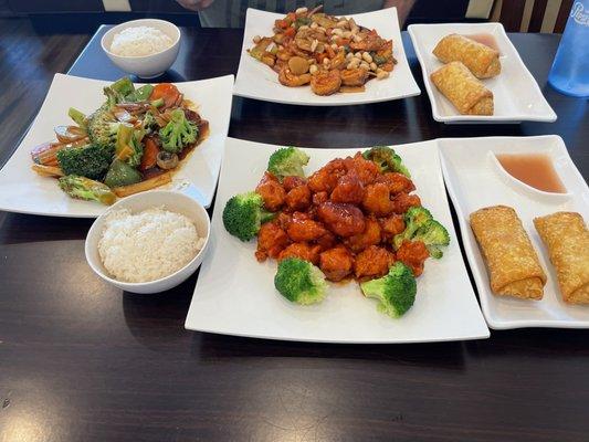 general sol chicken with rice, veggie eggroles, shrmp eggroles, kun poa shrimp with rice, and chinese veggies.