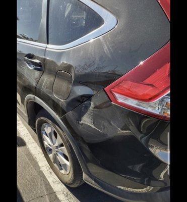 Big green landscaping truck's flatbed hit our car and took off.