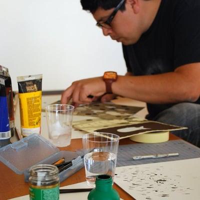 Artist Jose Arenas making an original artwork.