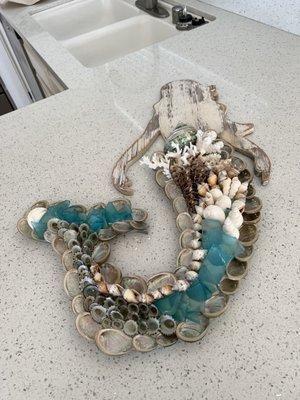 Wooden mermaid adorned with shells and sea glass