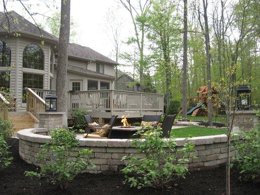 Full finished backyard with new deck, sitting area with fire pit, fresh new beds, and new plantings including fresh turf!