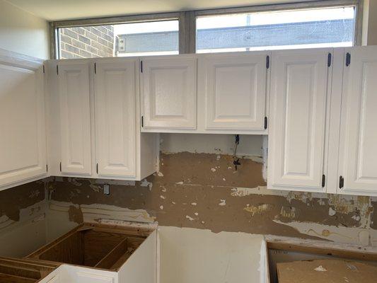 These upper kitchen cabinets were a wooden looking ,,now refinished in white