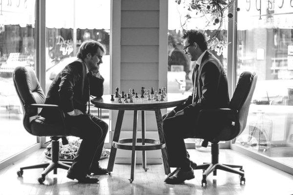 If you can beat Sam or David in a game of chess, they'll knock $100 off of your bill!