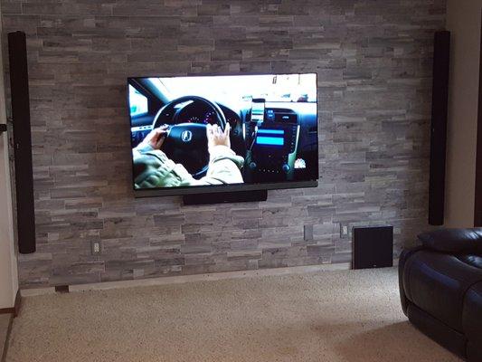 The tile back splash really makes the tv pop... we recessed the sub into the wall and flush mounted the sound bar right below the tv.