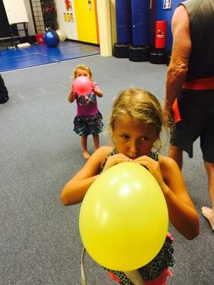 This is a game where students have to keep balloons in the air with their feet only!