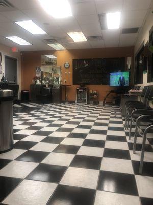 Waiting area with soft drinks for sale and a Tv to watch while waiting.