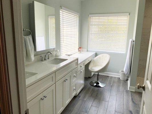 Brining the outdoors in with this bathroom renovation with the green walls and wood-look tile.