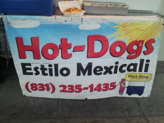 Sign In front of hot dog stand.