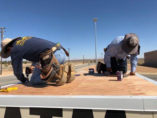 Installing a flat roof over an ATM machine in Edwards, California!