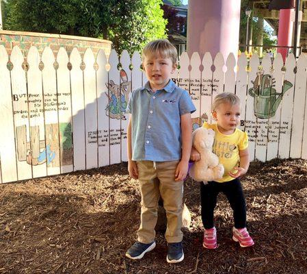 Peter Rabbit story on a white picket fence.