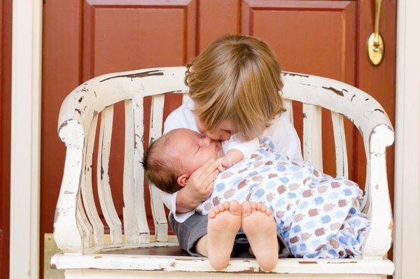 Help older siblings adjust to the new baby with a postpartum or adopted family doula.