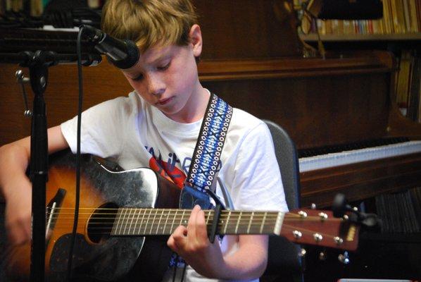 A student works the six string acoustic guitar!