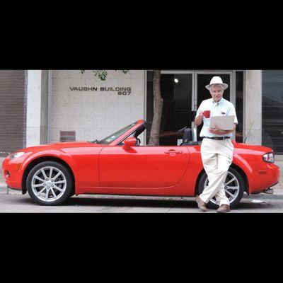 Robin with his red miata outside the office.