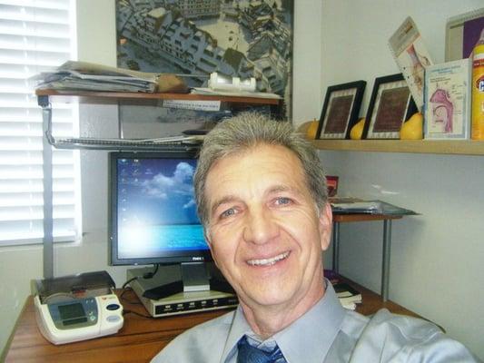 Dr. Neskovic in His Exam Room with Comuter and Electronic Health Records in the back.