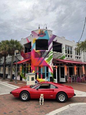 Munchie, the star of the Pizzeria's logo, poses naturally, in front of a classic Ferrari 308 GTB, and THE best pizzeria in the galaxy!