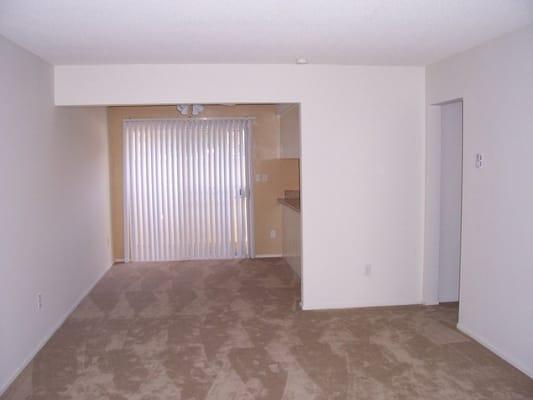 One bedroom, living room into dining room, with hallway to bedroom to the right