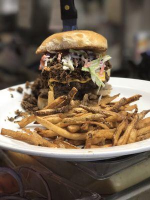 The Bubba Burger... Wagyu Burger stacked with onion rings, pickles, cheese, coleslaw, Bubba's BBQ chopped beef & sauce with fresh cut fries