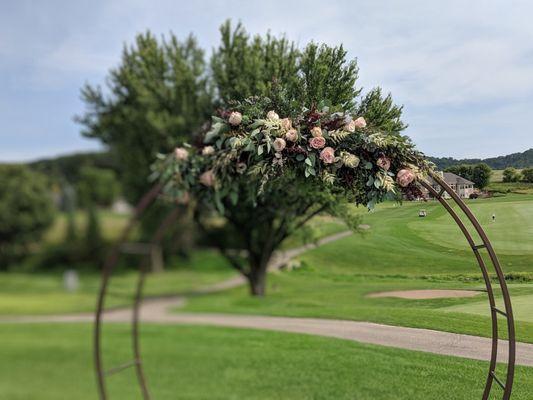 Floral designed arrangement on wedding ceremony arch