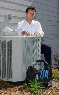 HVAC Technician Performing Air Conditioner Maintenance Services