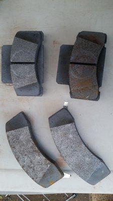 The ruined brake pads that were left in the bed of the truck upon arrival to pick up vehicle after repairs were claimed to be completed