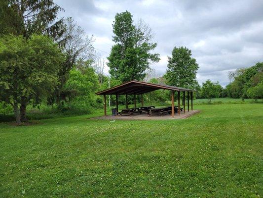 Open air shelter with picnic tables.