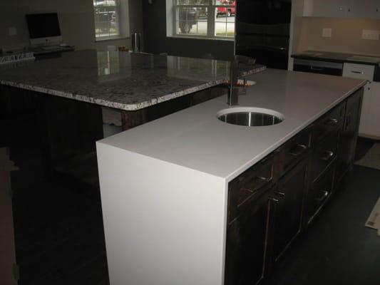 A Full Waterful Edge gives this Granite & Quartz Kitchen a European Flair.