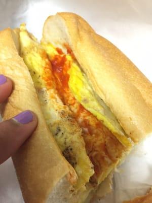 Egg and cheese with hot sauce on a roll. Delicious! Large portion for $2.50