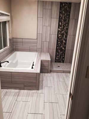 Master shower renovation using wood grained tile.