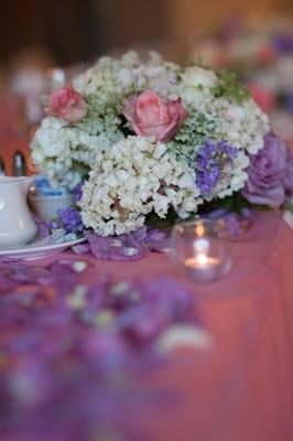 Purple petals on the table, and flower centerpieces