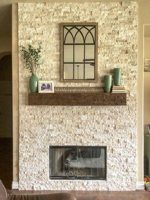 Full wall fireplace built with wooden mantel.