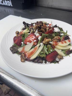 Mix greens with apples caramelized pecans strawberries