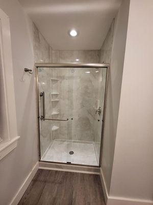 We installed a ceiling light for this client and look at how their new walk-in shower just pops with chrome fixtures!