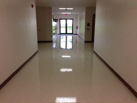 Removal of old wax and stains, following through with adding three layers of wax to restore the floor