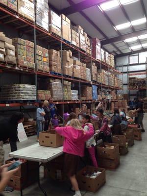 Troop #2266 making boxes of food for the many hungry families in central florida.